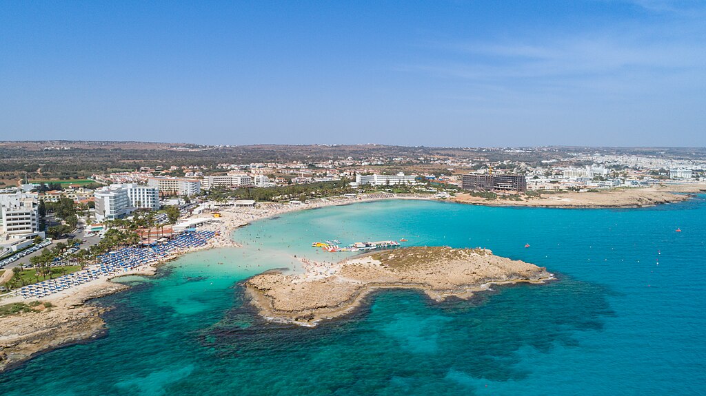 1024px-Nissi_bay_aerial_Cyprus_42818864975 | ReadZone